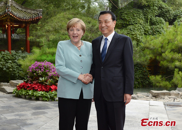 Chinese Premier Li Keqiang (R) shakes hands with German Chancellor Angela Merkel in Beijing, July 6, 2014.[Photo: China News Service/Liu Zhen] 