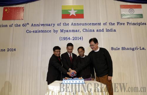 JOINT CELEBRATION: Officials from China, India and Myanmar cut a cake during a ceremony commemorating the 60th anniversary of the announcement of the Five Principles of Peaceful Coexistence in Yangon, Myanmar, on June 28 (XINHUA)
