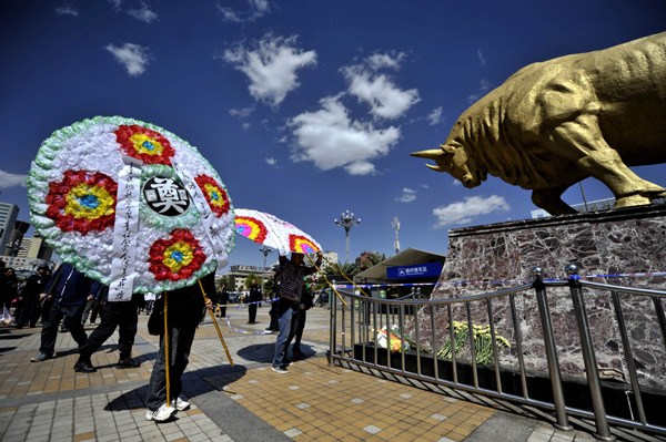 Kunming residents pay their respects to victims of the March 1 attack in the city. Hao Yaxin / for China Daily