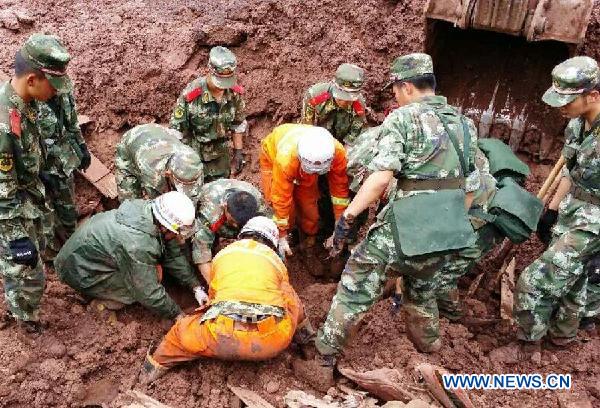 Photo taken with a cell phone shows rescuers searching for victims of a mudslide in Ludian county of Zhaotong city, southwest China's Yunnan province, July 7, 2014. (Xinhua/Zhang Rui)
