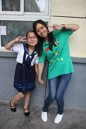 Xi Peiyao (left) poses with a volunteer of the Care for Girls program in Qingjian county, Shaanxi province, on July 2. Xi said her dream is to become a teacher. Wang Qingyun / China Daily
