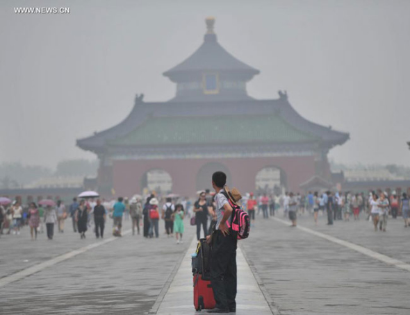 Fog shrouds the Temple of Heaven in Beijing, capital of China, July 3, 2014. Fog and smog hit Beijing on July 3 and serious pollution was reported by local environmental bureau. [Photo: Xinhua/Li Wen]