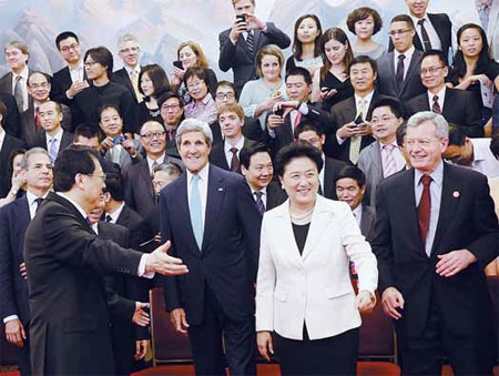 Vice-Premier Liu Yandong (center right), United States Secretary of State John Kerry (center left) and students and entrepreneurs from both countries pose for photos before the fifth annual US-China High-Level Consultation on People-to-People Exchange in Beijing on Thursday. Xu Jingxing / China Daily