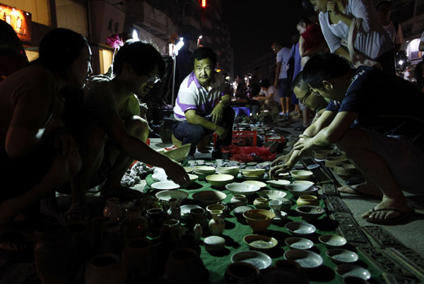 The 'Ghost Market', which is held every Monday at 4 am, is believed to be China's biggest street market for ceramics. Photos by Zhang Hao / for China Daily
