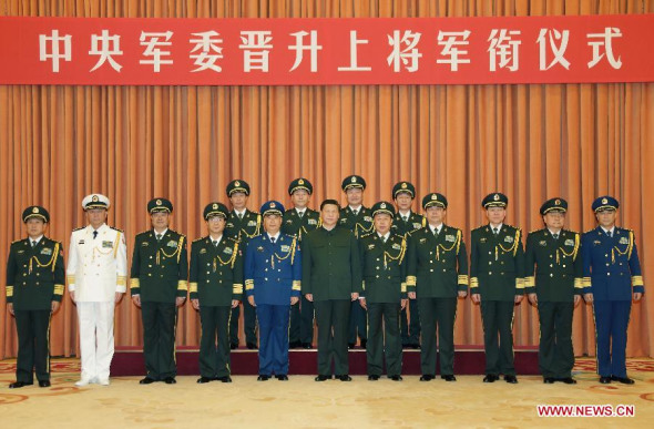 Chinese President Xi Jinping (C, front), who is also the chairman of China's Central Military Commission(CMC), poses for photos with officers after a promotion ceremony, during which the CMC promoted four senior military officers to the rank of general, the top rank at the current time, in Beijing, capital of China, July 11, 2014. (Xinhua/Li Gang)