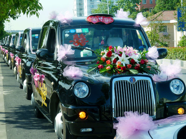 A wedding motorcade of classic British TX4 taxis drives along the street in Jiangsu province's capital Nanjing. Chinese weddings are often used to show off wealth. Wang Luxian / For China Daily 