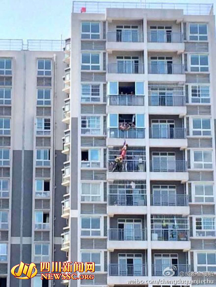 Woman who lives on the 12th floor attempted suicide by jumping out of her apartment window. However, she failed by falling onto the 11th floor neighbor's window getting stuck in the fence on July 13, 2014 in west China's Chengdu. [Photo:newssc.org]