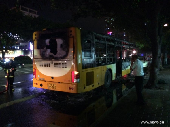 Photo taken on July 15, 2014 shows the burned bus in Guangzhou, capital of south China's Guangdong Province. Two people died and at least six others were injured in a bus explosion in Guangzhou Tuesday evening, police said. (Xinhua/Fu Qing)