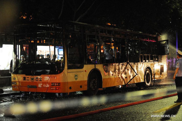 Photo taken on July 15, 2014 shows the burned bus in Guangzhou, capital of south China's Guangdong Province. Two people died at the scene and 32 were landed in hospital with injuries after the bus explosion in Guangzhou on Tuesday evening. [Photo/Xinhua]