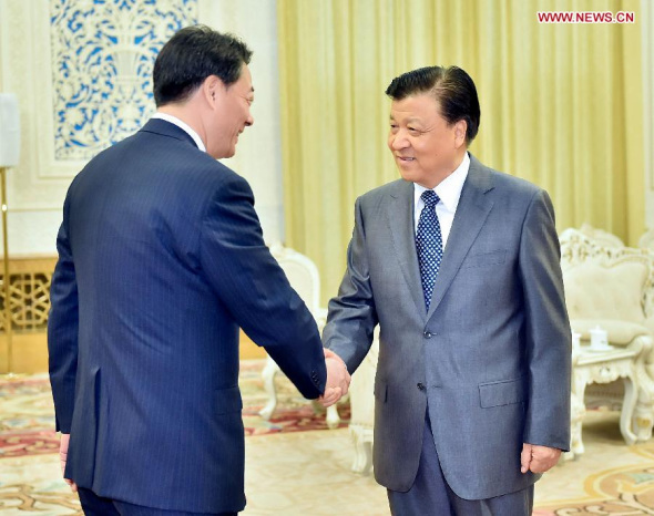 Liu Yunshan (R), a member of the Standing Committee of the Political Bureau of the Communist Party of China (CPC) Central Committee, meets with Banri Kaieda (L), leader of Democratic Party of Japan, in Beijing, capital of China, July 16, 2014. (Xinhua/Li Tao)