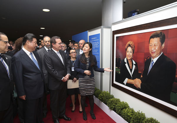 President Xi Jinping pays a visit to an exhibition marking the 40th anniversary of diplomatic relations between China and Brazil in the Brazilian capital of Brasilia on Wednesday. Lan Hongguang / Xinhua