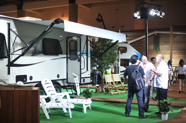 Traders talk outside an exhibition section for recreational vehicles during the trade show in Beijing.