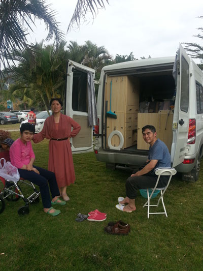 Liu Da'nian, his wife and daughter take a rest by their RV during one of their trips around the country. Provided to China Daily