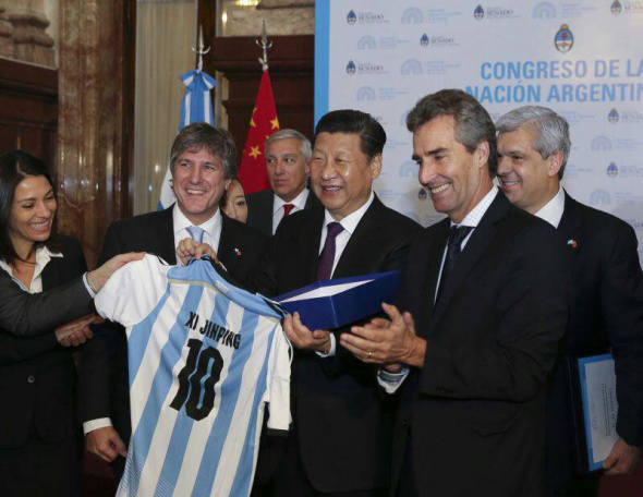 China's President Xi Jinping (R3) receives an Argentine soccer jersey with his name on it from Argentina's Vice President Amado Boudou as Xi visits the Congress in Buenos Aires July 19, 2014. [Photo/Ding Lin]