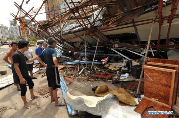 A building collapses on a motorcar after landfall of the typhoon Rammasun in Haikou, capital of south China's Hainan Province, July 19, 2014.  (Xinhua/Xia Yifang)
