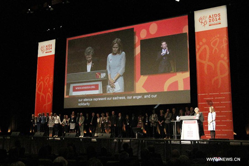 President of the International AIDS Society (IAS) Francoise Barre-Sinoussi from France (2nd R) and other delegates observe a moment of silence during the opening of the 20th International AIDS Conference at the Melbourne Convention and Exhibition Centre (MCEC) in Melbourne, Australia, on July 20, 2014. At least six delegates heading for Melbourne to join the 20th international AIDS conference were killed in the crash of Malaysian flight MH17. (Xinhua/Xu Yanyan)