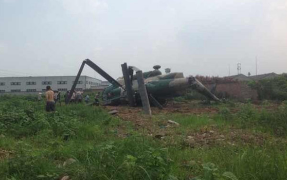 A military helicopter crashed at a site where villagers say they see such choppers regularly. [Photo: theBeijingnews]