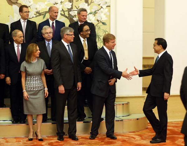 Premier Li Keqiang (right) shakes hands with US representatives at the Sixth Annual China-US CEO and Former Senior Officials' Dialogue in Beijing on Tuesday. Wu Zhiyi / China Daily