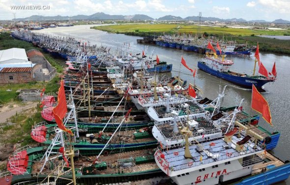 Fishing boats take shelter at the Jinqing Fishing Port to avoid Typhoon Matmo in Taizhou City, east China's Zhejiang Province, July 22, 2014. Typhoon Matmo, the 10th typhoon to affect China this year, was approaching China's southeast coast on Tuesday. (Xinhua/Tao Wenbiao)