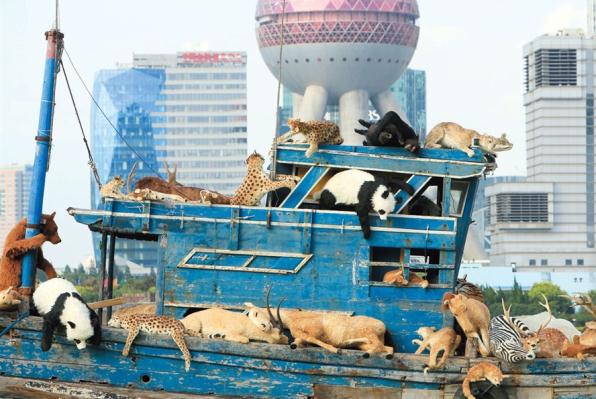 A boat of 99 fabricated animals cruises on the Huangpu River in Shanghai.  Wang Rongjiang/Shanghai Daily