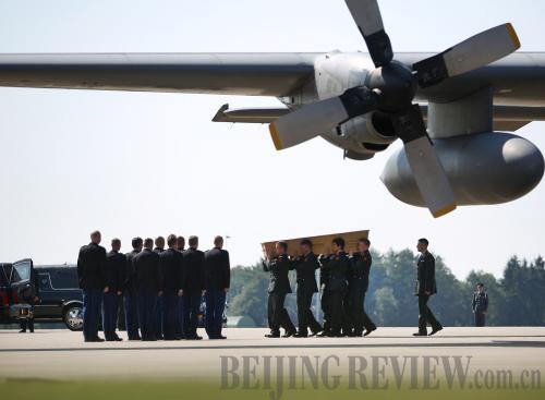 PAYING RESPECT: Military personnel carry a coffin belonging to one of the victims of the crash of the Malaysia Airlines flight MH17 on July 23, in Eindhoven, Netherlands (XINHUA)