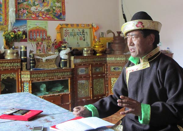 Monk-turned farmer Tsering recites a poem. He says religion and helping others make him happy. Palden Nyima / China Daily