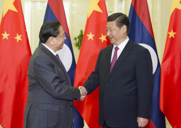 Chinese President Xi Jinping (R), also General Secretary of the Communist Party of China Central Committee, holds talks with Secretary General of Lao People's Revolutionary Party Choummaly Saygnasone, in Beijing, China, July 28, 2014. (Xinhua/Huang Jingwen)