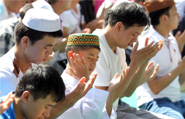 Muslims pray at Niujie Mosque in China's capital on Aug 8 as they gather to celebrate Eid Al-Fitr. The three-day festival marks the end of Ramadan, Islam's holy month of fasting. [Zou Hong/Asianewsphoto]