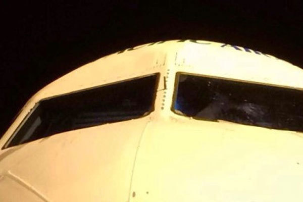 Picture provided by an Internet user shows a hole in the windshield of the airplane that was forced to land in Shanghai on July 30.