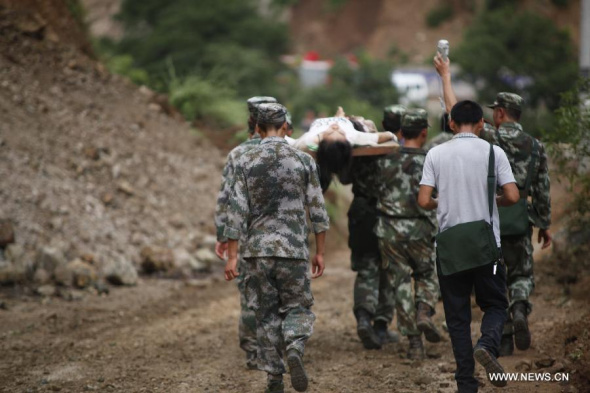 Rescuers transport an injured woman after an earthquake in Ludian County of Zhaotong City in southwest China's Yunnan Province, Aug 3, 2014. (Xinhua/Zhang Guangyu) 