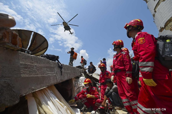 A helicopter transferring injured people or relief materials flies over quake-hit Longtoushan Town of Ludian County, southwest China's Yunnan province, Aug 5, 2014. (Xinhua) 