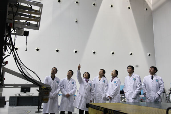 Members of a space control research team from the China Academy of Space Technology in Beijing discuss how their lunar probe will perform during rendezvous and docking procedures. Provided to China Daily