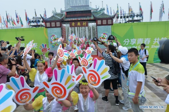 The Olympic flag is raised during the opening ceremony of the Youth Olympic village ahead of the Youth Olympic Games in Nanjing, capital of east China's Jiangsu Province, Aug, 12, 2014. The Nanjing 2014 Youth Olympic games will be held from August 16 to 28. (Xinhua/Shen Peng)