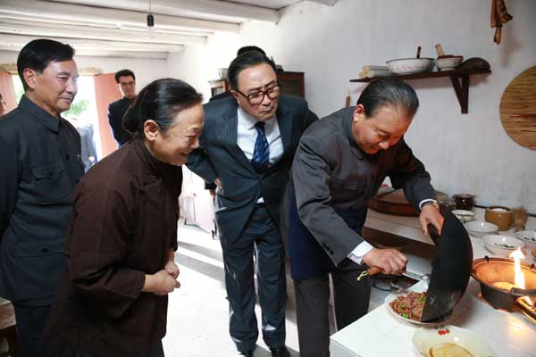 In a scene from the new production, Deng cooks a dish at a civilian's house. [Photo/China Daily]