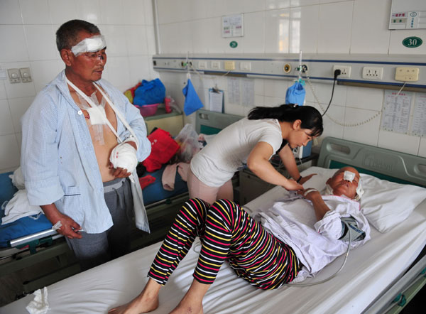 Villagers attacked by wolves are cared for at Xinjiang People's Hospital on Tuesday. Zhu Yi / For China Daily