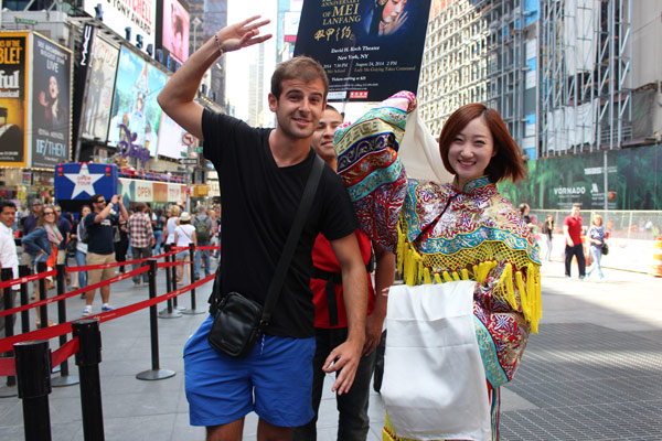 A performer (right) from the 120th anniversary of Mei Lanfangfrom Jingju Theater Company of Beijing poses with a visitor in Times Square, New York City on Tuesday. The performance will be at the David H. Koch Theater on Wednesday, Saturday, and Sunday, tickets are still available. Elizabeth Wu / China Daily