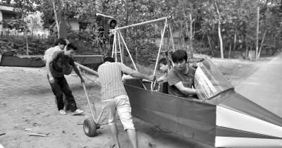 Guo sits in the plane he made. 