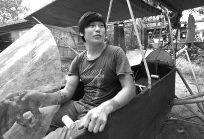 Guo sits in the plane he made. 