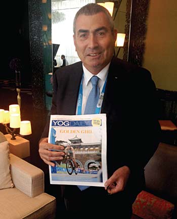Ugur Erdener, the Turkish Olympic Committee president and member of the IOC Executive Board, holds the YOG Daily. PHOTO BY SUN XIAOCHEN / CHINA DAILY
