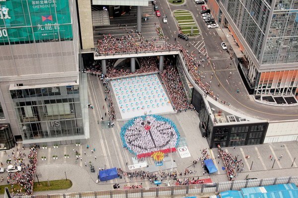 Exactly 1,293 volunteers stand in formation to create a portrait of Doraemon, one of the most popular Japanese cartoon characters, in Chengdu, on Aug 16. Photo provided to China Daily