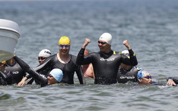 Swimmers arrive in Pingtan, Fujian province, on Friday after a five-day relay across the Taiwan Straits. Bao Hua / for China Daily