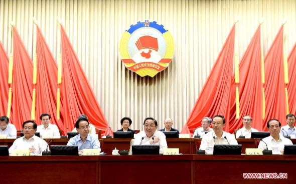 Yu Zhengsheng (C), chairman of the National Committee of the Chinese People's Political Consultative Conference (CPPCC), attends the closing meeting of the 7th conference of the Standing Committee of the 12th CPPCC National Committee in Beijing, capital of China, August 27, 2014. (Xinhua/Ma Zhancheng)