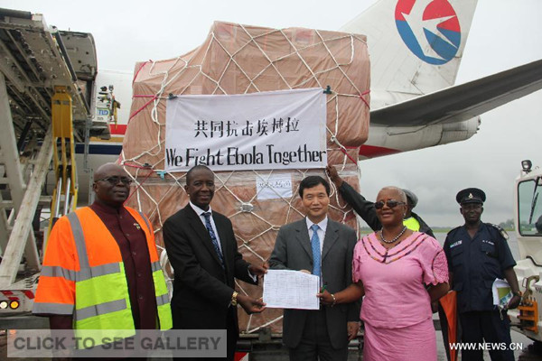 Chinese Ambassador to Sierra Leone Zhao Yanbo (2nd R, front), Deputy Minster of Foreign Affairs of Sierra Leone Ebun Strasser-King (1st R, front) and Sierra Leone's Deputy Minister of Health Abu Bakar Fofanah (2nd L) attend a transferring ceremony of emergency humanitarian supplies provided by China at the airport in Freetown, capital of Sierra Leone, Aug. 11, 2014. A Chinese plane carrying emergency humanitarian supplies for Sierra Leone arrived in the country's capital Freetown on Monday afternoon, as part of effort to help the country contain the spread of Ebola. (Xinhua) 