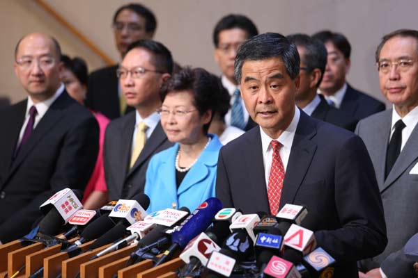 Chief Executive CY Leung and other senior Hong Kong officials meet the media after the decision was announced on Sunday. [Photo by Edmond Tang / China Daily]