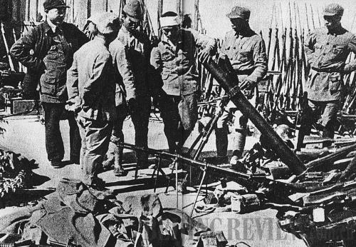 UP IN ARMS: Japanese soldiers surrender their weapons to the Chinese army during the war (XINHUA)