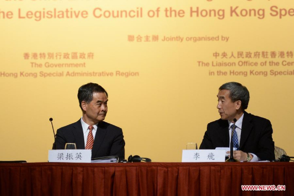 Li Fei (R), vice secretary-general of the National People's Congress (NPC) Standing Committee, talks with Hong Kong Chief Executive C Y Leung at a briefing session in Hong Kong, south China, Sept 1, 2014. (Xinhua/Qin Qing) 