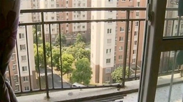 A balcony with broken rails is seen at the apartment complex in Minhang District. 