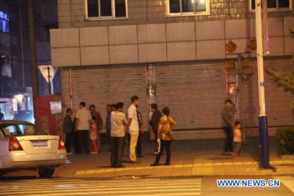 People stand outside after an earthquake in Zhuolu County, north China's Hebei Province, Sept. 6, 2014. A 4.3-magnitude earthquake jolted Zhuolu County at 6:37 p.m. (Beijing Time) on Saturday, the China Earthquake Network Center said. No casualties have been reported so far. (Xinhua)