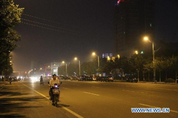 A man rides on a road in Zhuolu County, north China's Hebei Province, Sept. 6, 2014. A 4.3-magnitude earthquake jolted Zhuolu County at 6:37 p.m. (Beijing Time) on Saturday, the China Earthquake Network Center said. No casualties have been reported so far. (Xinhua)