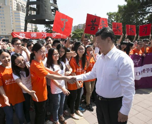 Chinese President Xi Jinping shakes hands with teachers and students at Beijing Normal University in Beijing, capital of China, Sept 9, 2014. [Photo/Xinhua]